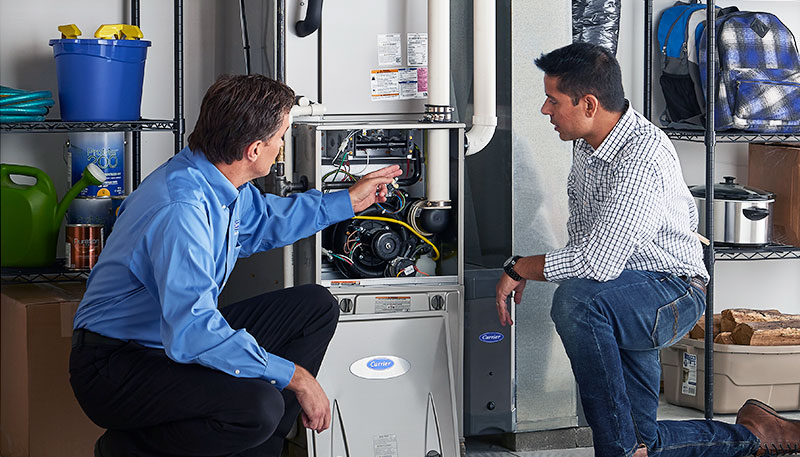 HVAC technician evaluating a furnace for repair or replacement in Westminster