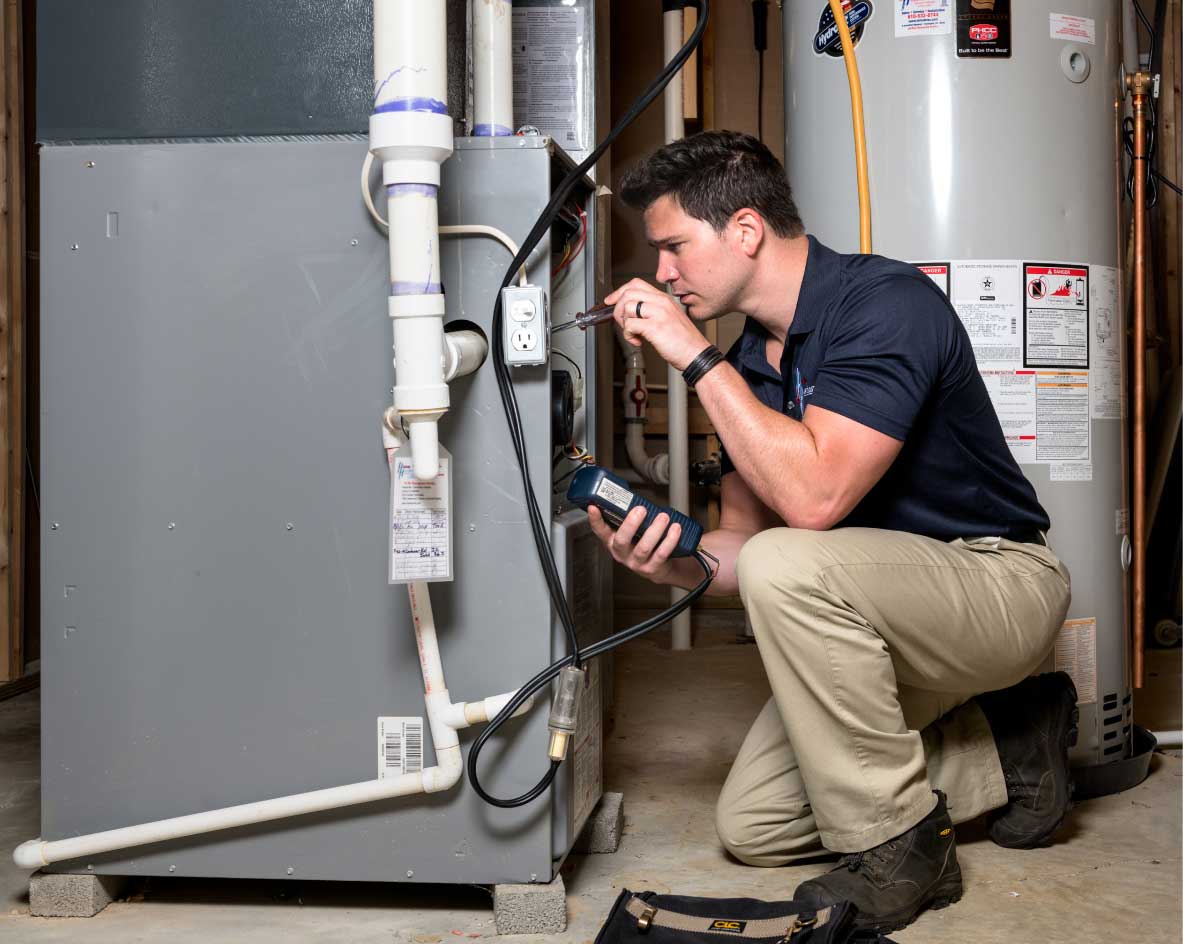 HVAC technician performing a furnace tune-up in Westminster
