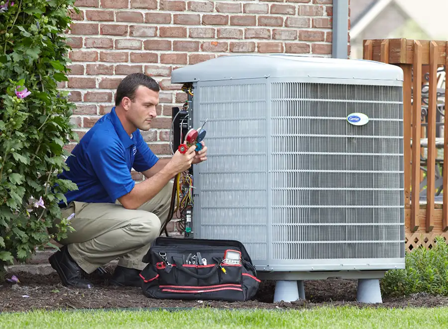 HVAC technician inspecting an outdoor air conditioning unit in Westminster