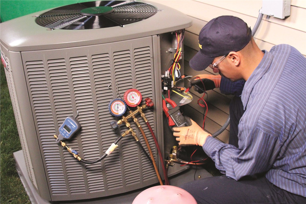 HVAC technician testing an outdoor air conditioning unit in Westminster