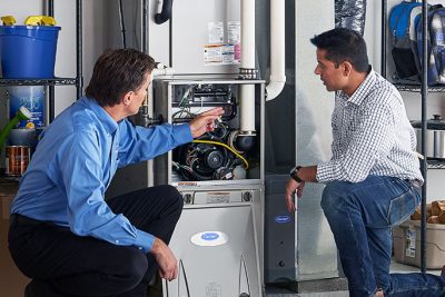 HVAC technician explaining furnace repair and maintenance to a homeowner in Westminster, CO